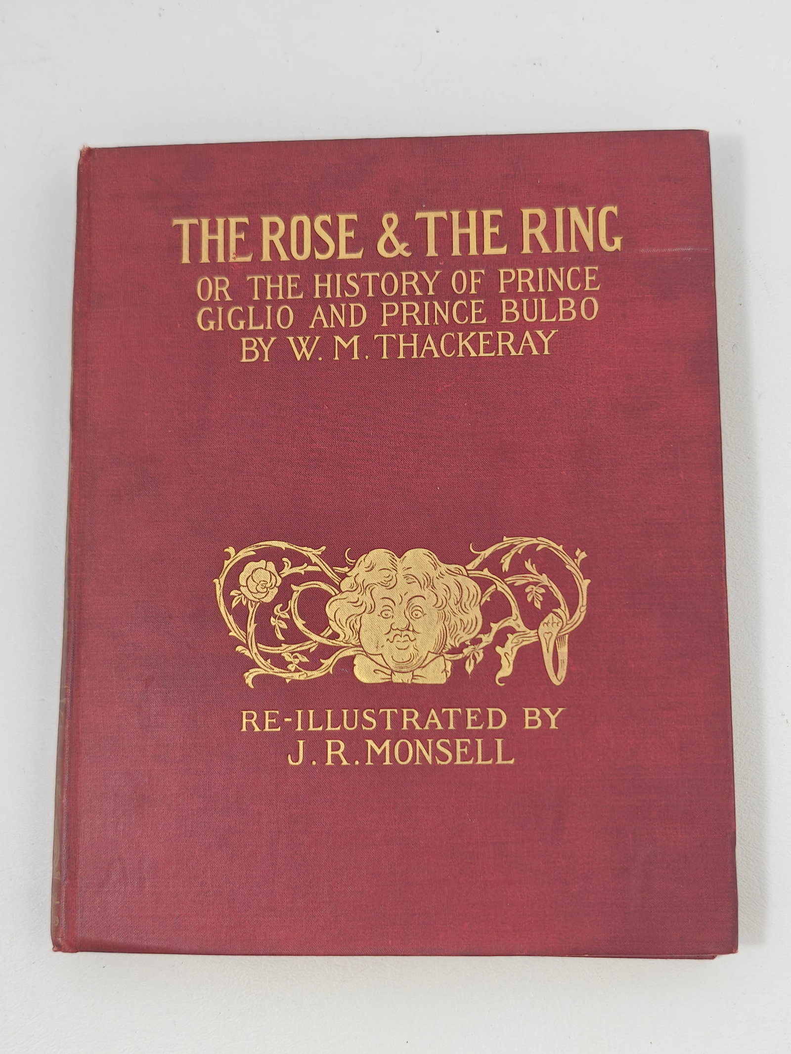 1911 W.M. Thackeray The Rose and the Ring Illustrated by J.R. Monsell: W.M. Thackeray's The Rose and the Ring; or, The History of Prince Giglio and Prince Bulbo, published by Kegan Paul, Trench, Trübner & Co., London, 1911. Red cloth binding with elaborate gilt decorati