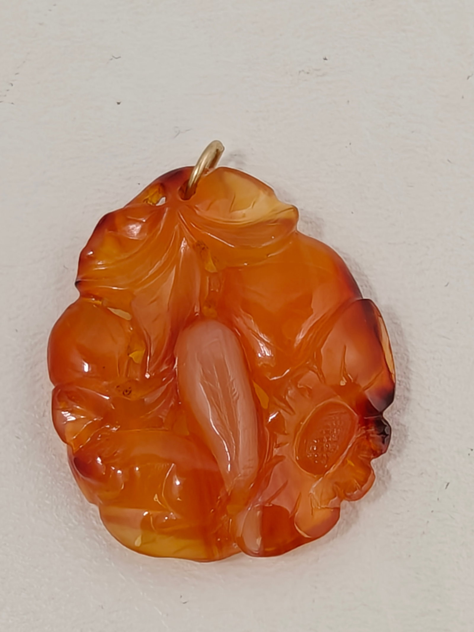 Hand-Carved Carnelian Agate Fruit & Floral Pendant: Hand-carved carnelian agate pendant depicting a fruit and floral motif with attractive natural orange, amber, cream, and reddish banding. The relief carving is finely executed and highlights the stone