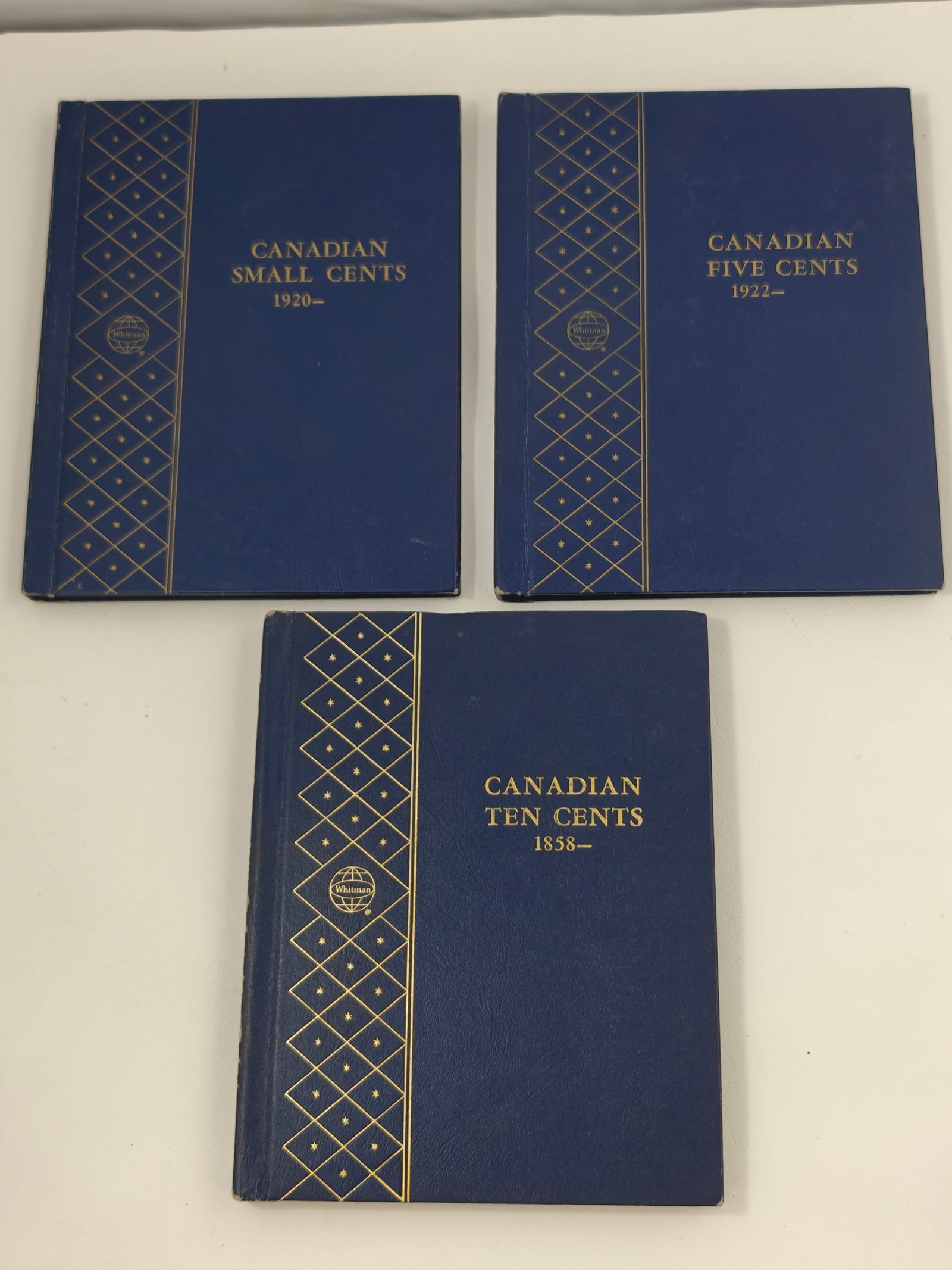 Three Whitman Canadian Coin Albums with Partially Complete Collections: Three vintage Whitman Canadian coin albums including Canadian Small Cents (1920-), Canadian Five Cents (1922-), and Canadian Ten Cents (1858-). The albums contain partially complete collections spanni