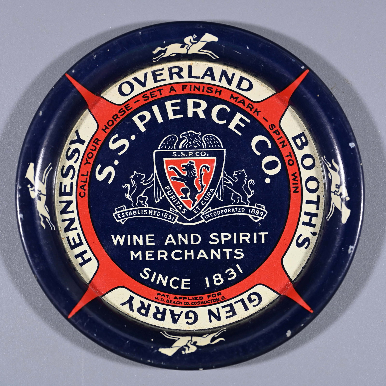 S.S. Pierce Co. Wine and Spirit Merchants Spinner / Tip Tray: This was designed as a gambling device to determine who pays the bar tab. See the back; there's a pimple in the center that allows it to spin. As stated in the red: Call Your Horse [by brand] - Set a 