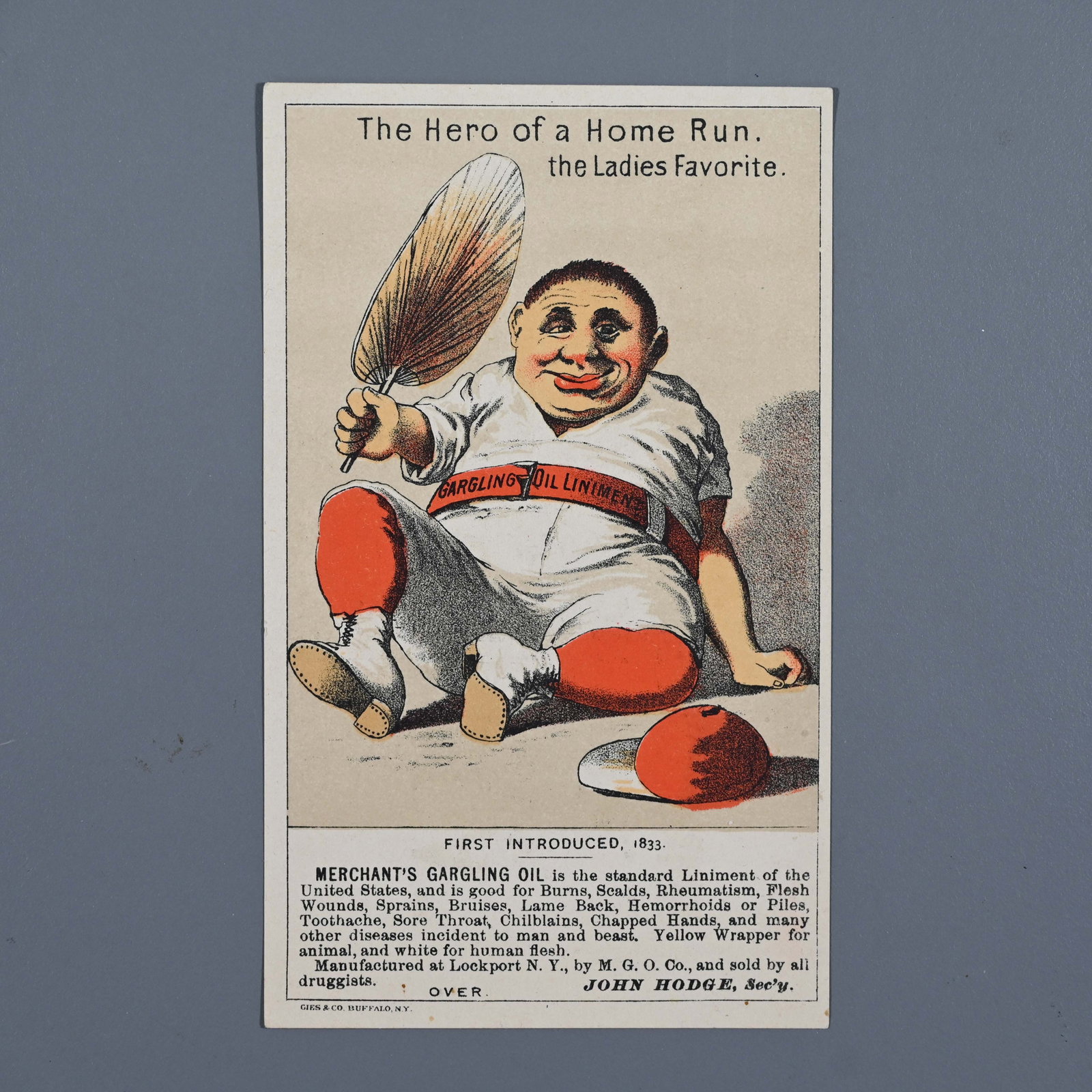 Baseball Card - Merchant's Gargling Oil - Hero of Home Run: Baseball - The Hero of a Home Run. The Ladies Favorite - Victorian trade card. On his belt Gargling Oil Liniment. Printed by Geis & Co Buffalo N.Y. The back advertises O.F.R. / Open Face Roll La Norma