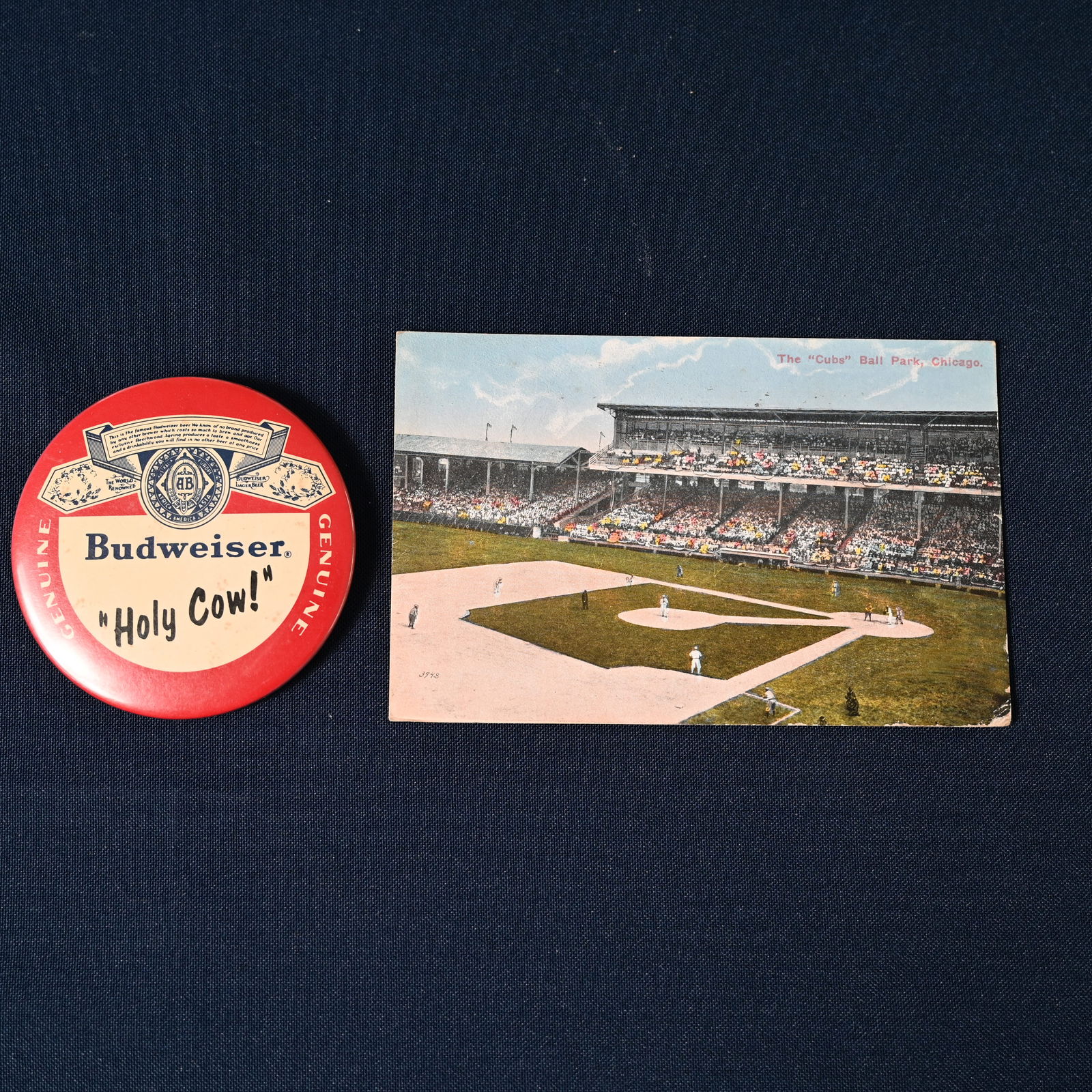 Budweiser Holy Cow Button & Wrigley Field Postcard: Holy Cow was the catchphase of Harry Carey the Chicago Cubs broadcaster, 1982 - 1997. He is credited of with making the singing of Take Me Out to the Ball Game during the seventh inning stretch a