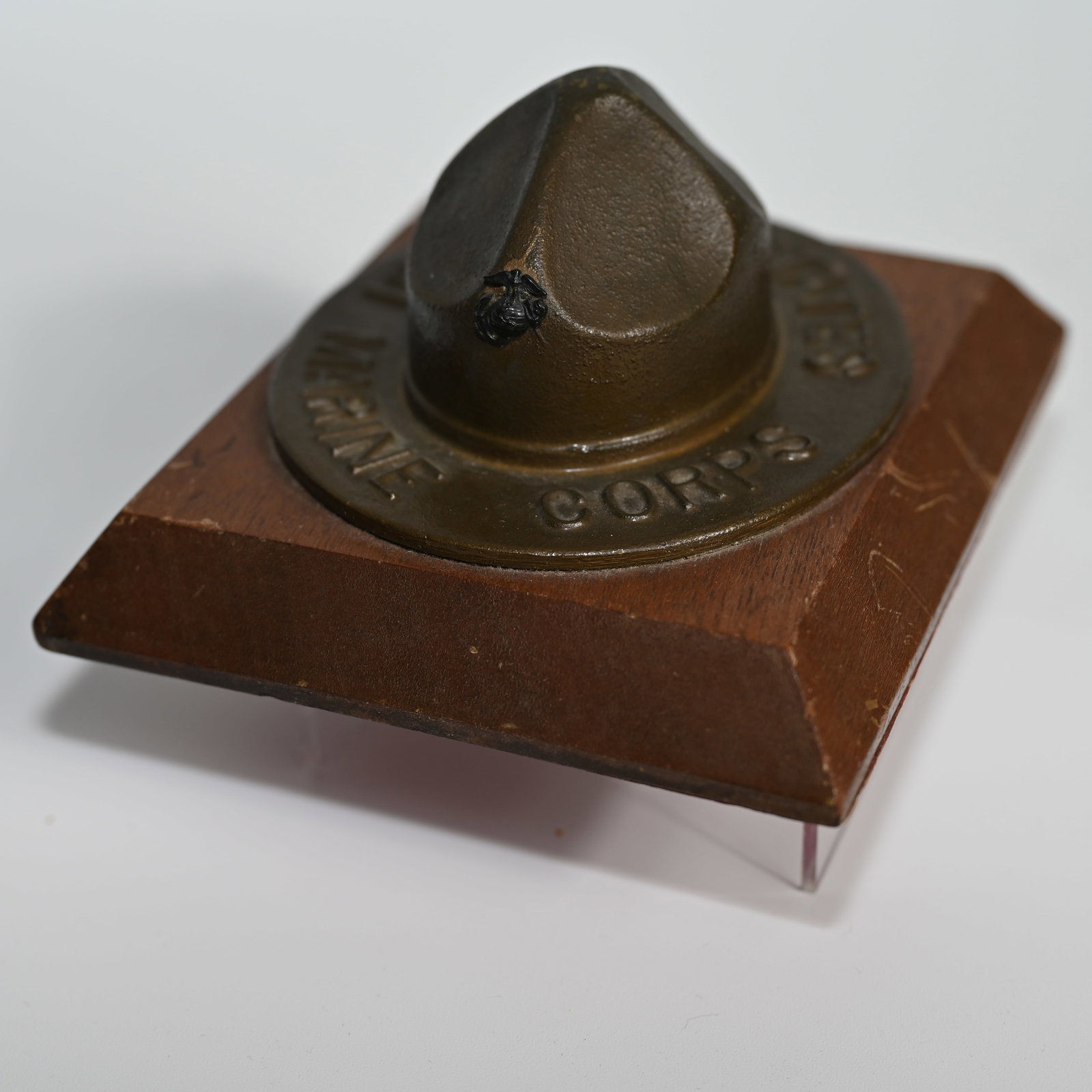 United States Marine Corp Campaign Hat Paperweight: Marked United States Marine Corps on rim. In olive drab green - also called OD green - or olive green, a color adopted in about 1912 by the US Marines for gear and uniforms. On base, Copyright Pending