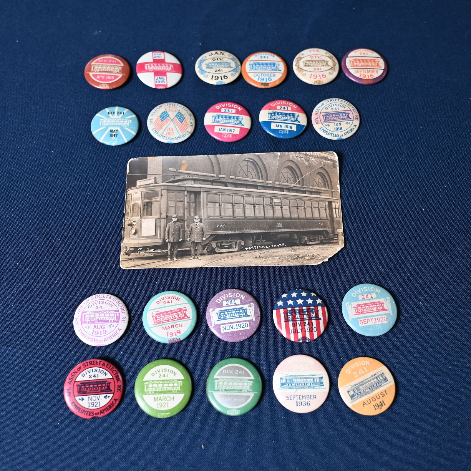Collection of 21 Transit Employees Union Chicago Local 241 Pin - Pinback: 1915 to 1941. Most produced by J.L. Lynch. Some by Geraghty & Company. Together with a Street Car Photo, likely Chicago. The street name is consistent with Chicago. History: A.A. of S. & E.R.E.