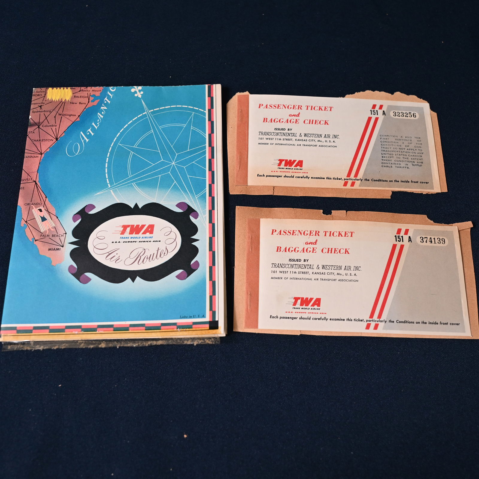 TWA Air Routes Map - Domestic & Int'l - plus 2 Used Tickets 1948: (1) A fold out map from TWA illustrating domestic and international air routes. The map was removed from a scrapbook. It was taped in by the bottom edge. The tape remains; we did not attempt to remove