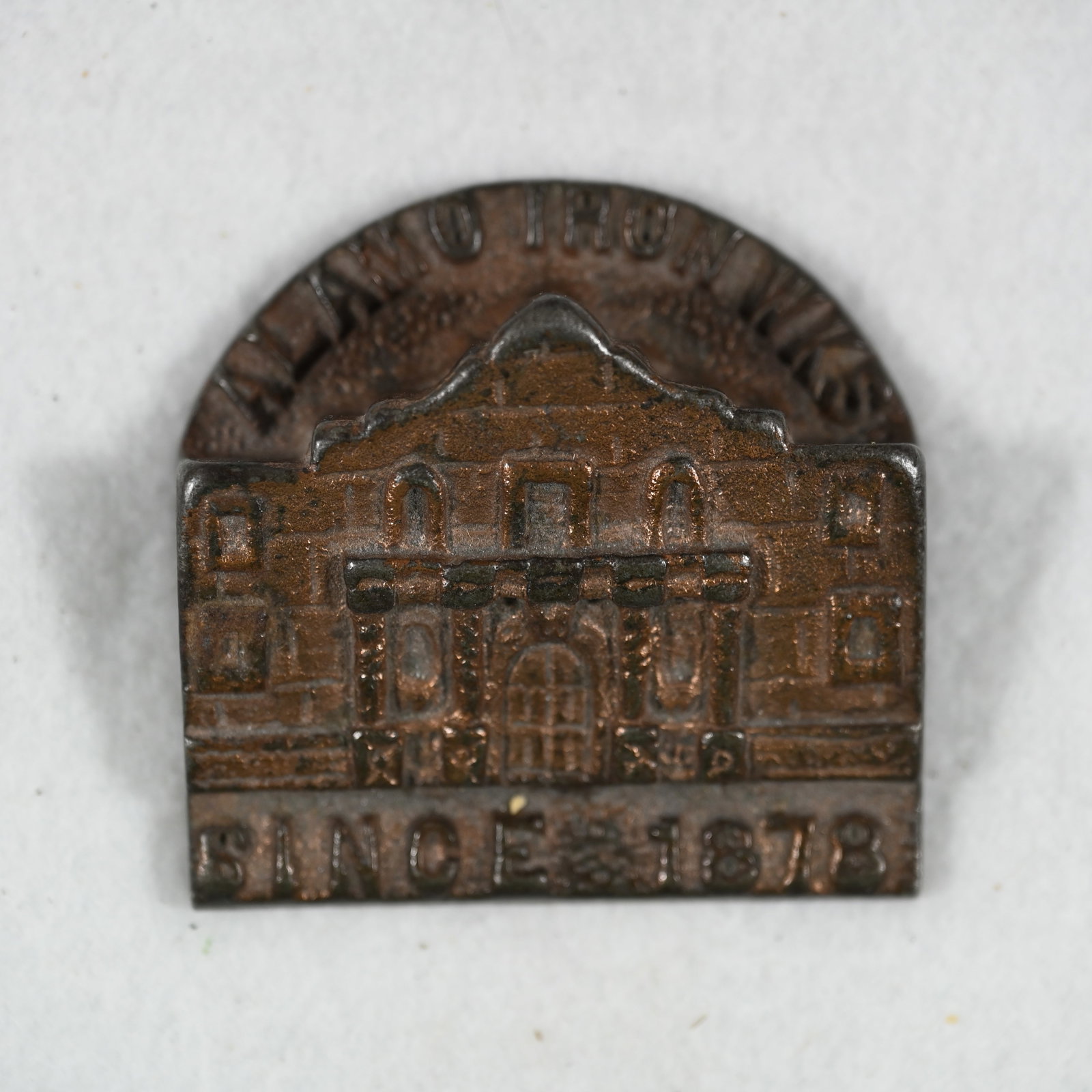 Alamo Iron Works Since 1878 Advertising Paperweight: Alamo Iron Works Since 1878 cast iron advertising paperweight similar in design to a bill clip. Marked For Better Castings on the bottom. About 2 1/2 x 2 1/2 x 3/4 inches