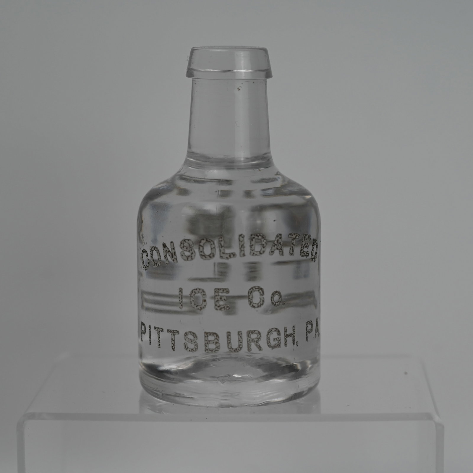 Consolidated Ice Co Pittsburgh Advertising Paperweight: While likely a paperweight, it may also have been a point of sale advertising display. Consolidated Ice Co Pittsburgh painted on the front. Pure Distilled Water painted on the back. About 4 1/4 x 2 1/