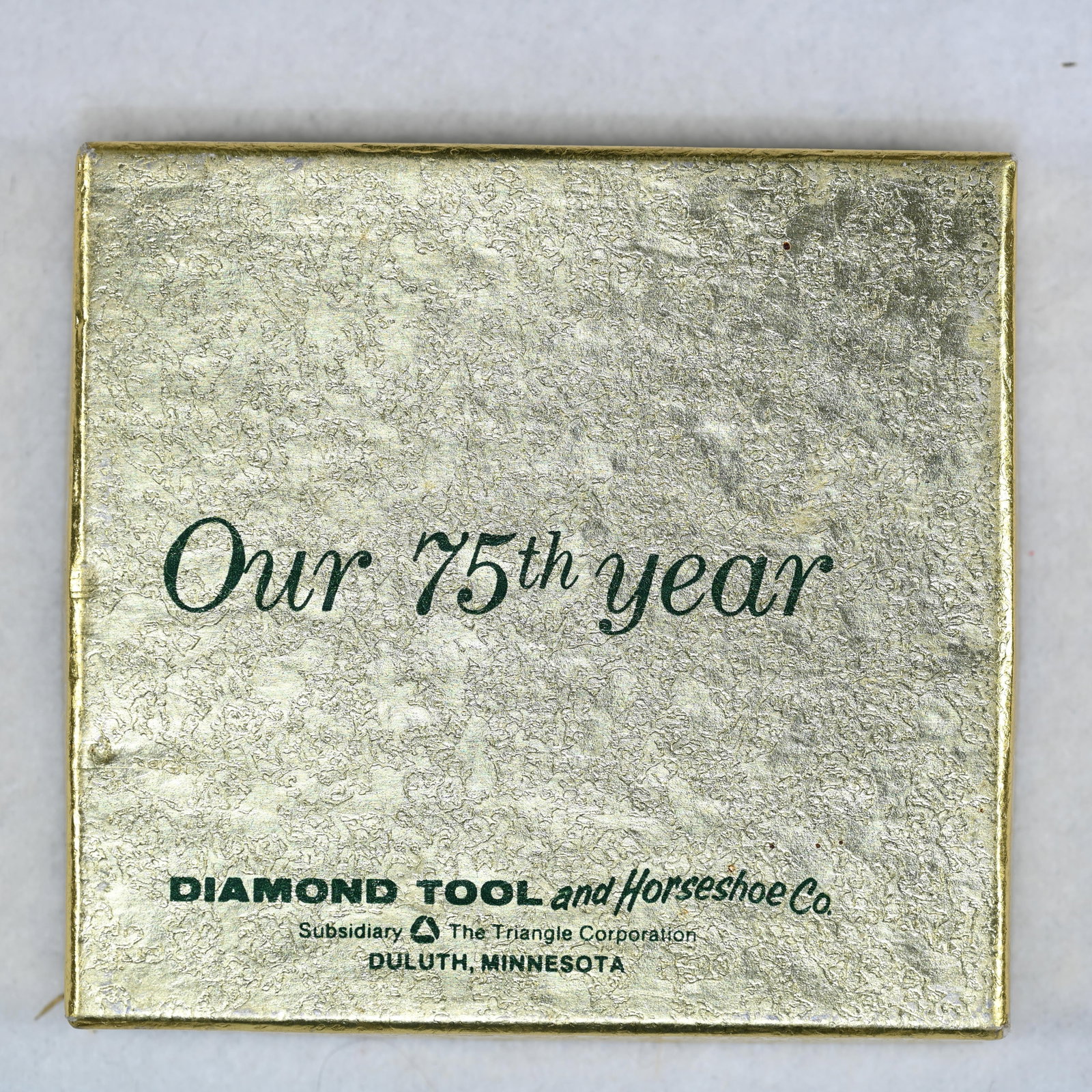 Diamond Tool and Horseshoe Co. 75th Anniversary Advertising Paperweight: 1983 75th Anniversary Diamond Tool and Horseshoe Subsidiary The Triangle Corp. It is made of brass and features an adjustable pair of pliers, a signature product, at the top. History: The company was 