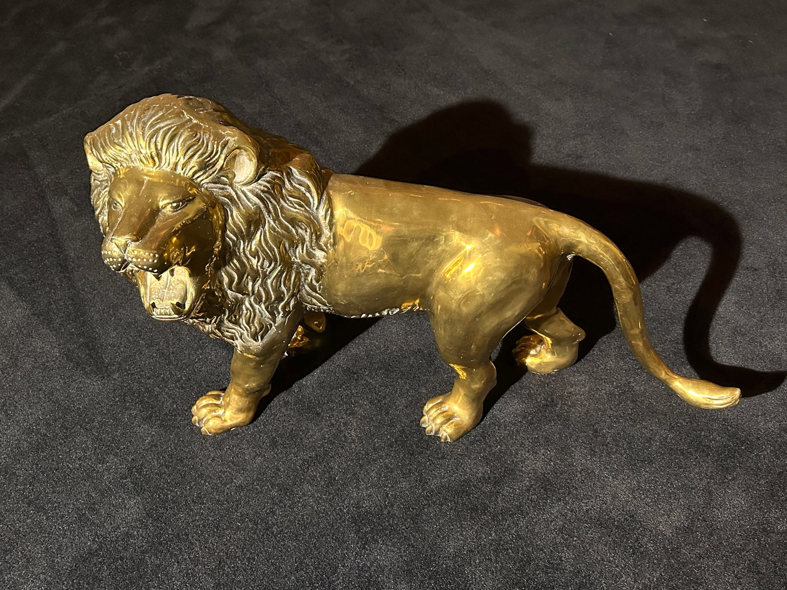 XXL Brass African Lion Sculpture HUGE and we mean HUGE: XXL Brass African Lion HUGE and we mean HUGE. This is approximately 41 INCHES LONG by 25 INCHES TALL and 14 inches deep. This lion is one of the most impressive we have ever seen. It is really hard to