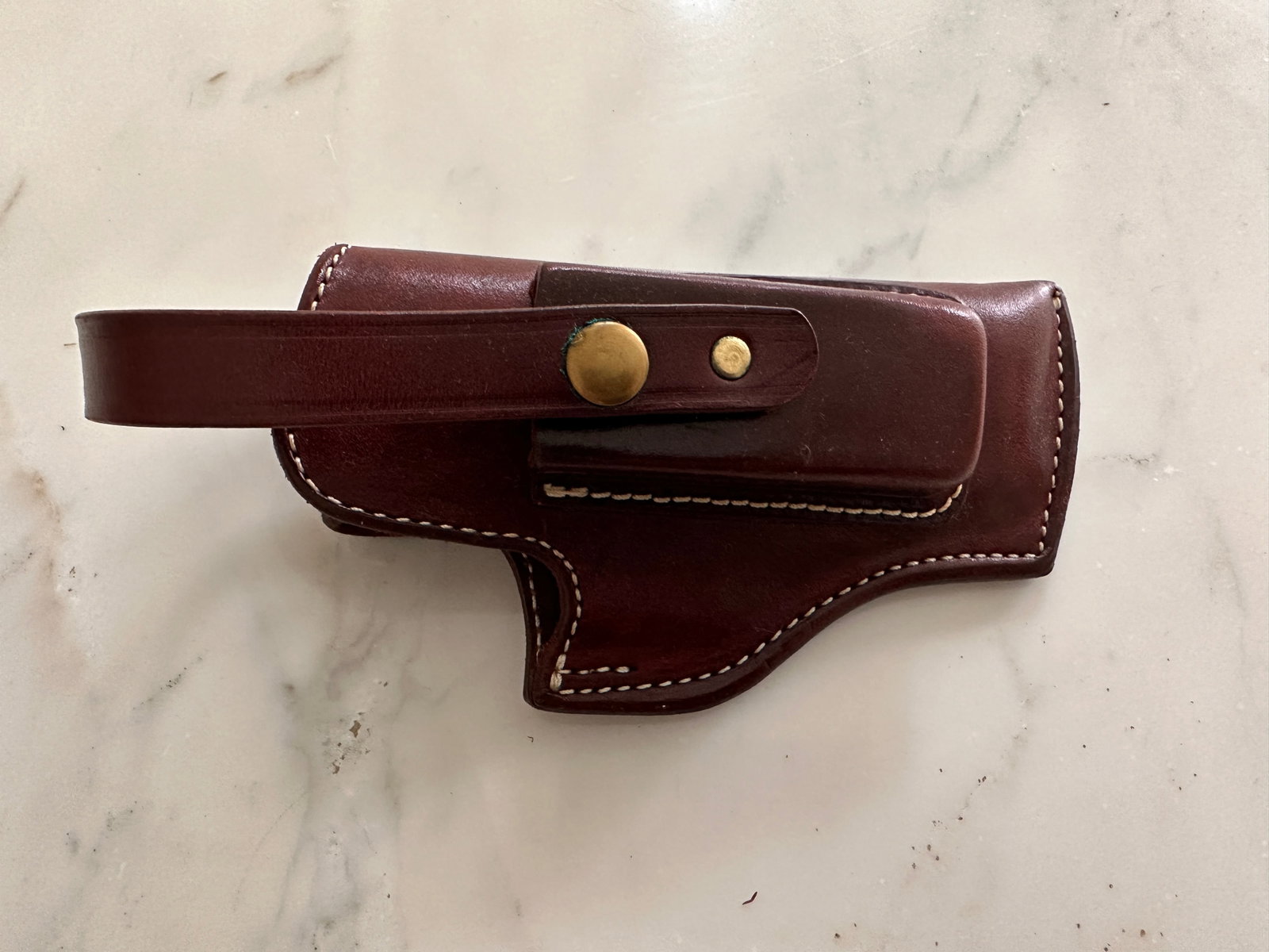 Leather holster: Leather holster that is approximately 8 1/2 inches long by 4 inches wide by 3 inches thick Marked K 39-33.