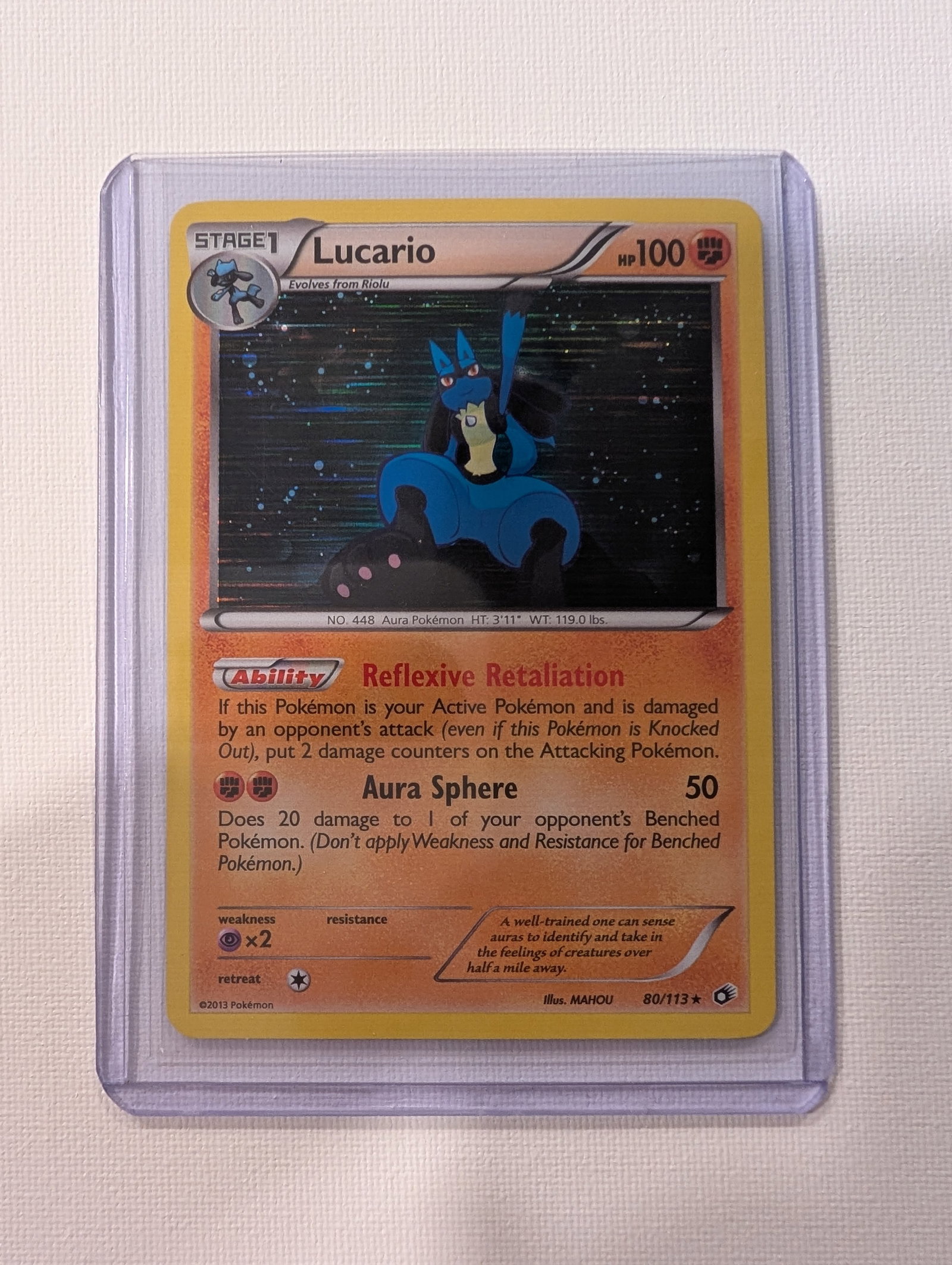 VERY RARE 2013 Pokemon Lucario 80 113 Legendary Treasures Holo: This lot is a VERY RARE Lucario Holo card numbered 80 113 from the 2013 Legendary Treasures set. The card is in English and features the Reflexive Retaliation ability and the Aura Sphere attack.