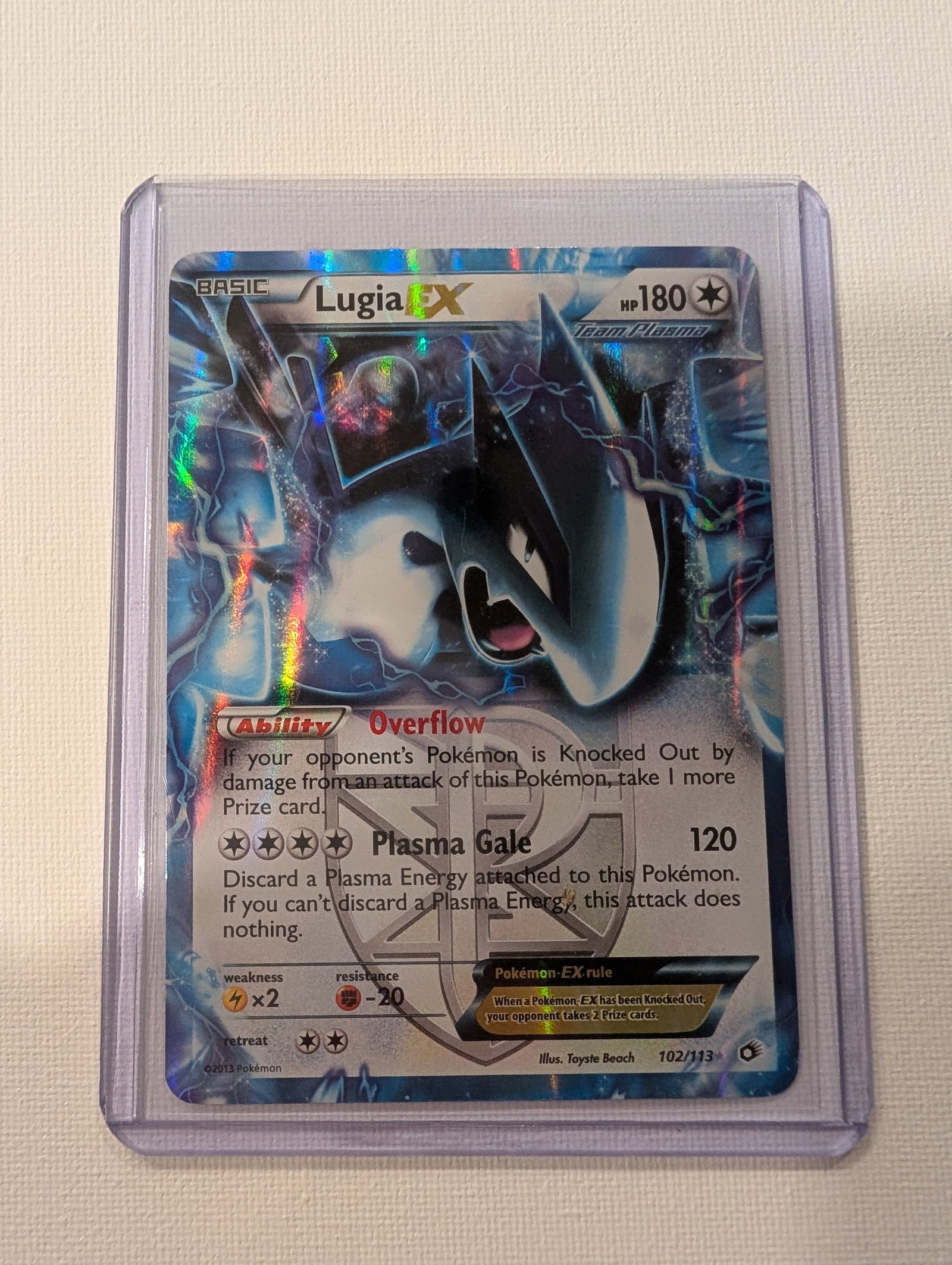 SUPER RARE 2013 Pokemon Lugia EX 102 113 Plasma Storm Full Art: This lot is a Team Plasma Pokemon with 180 HP and features artwork by Toyste Beach. The card includes the Overflow ability which allows the player to take an extra prize card when an opponent is knock