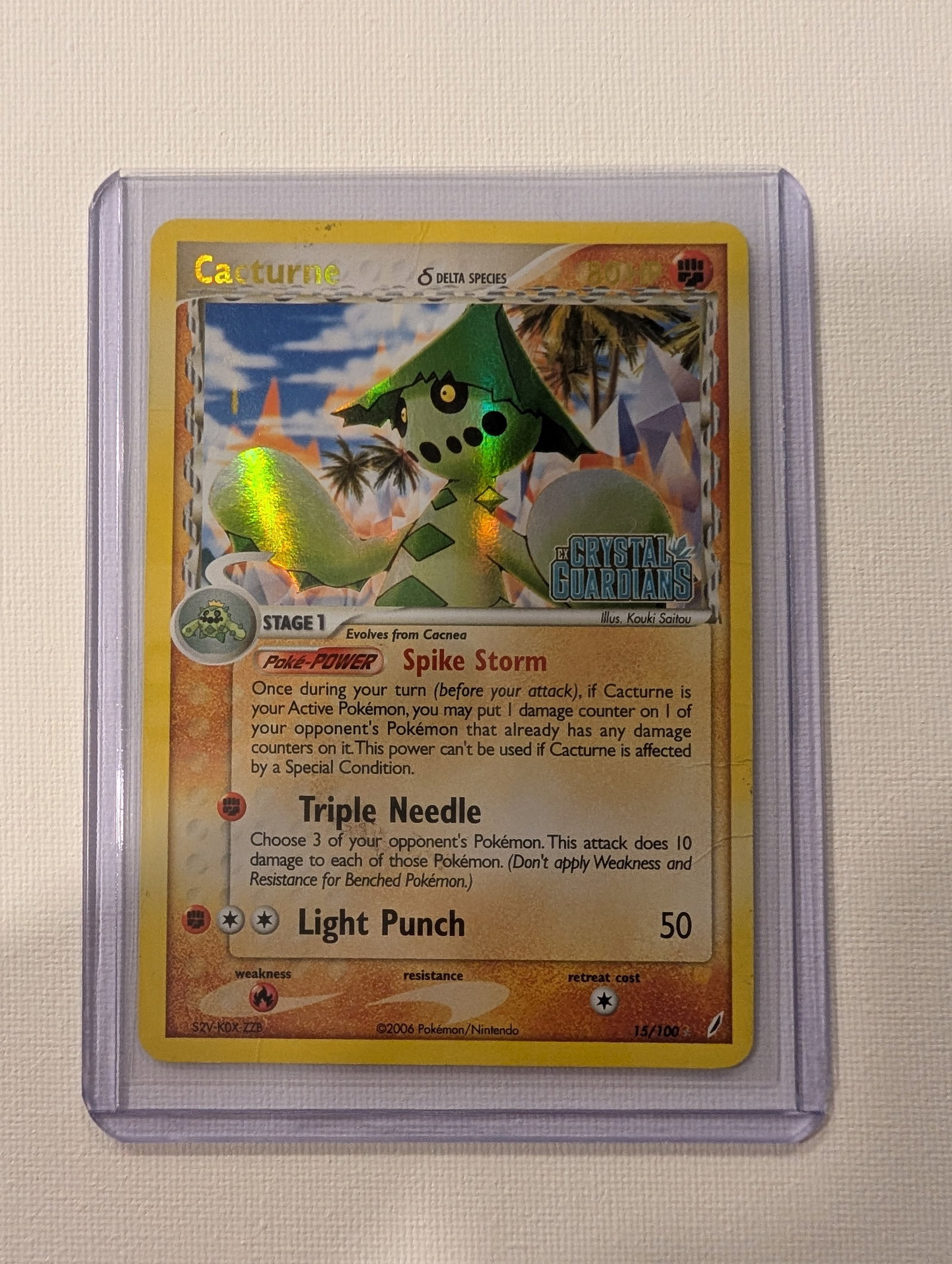 2006 Pokemon Cacturne 15 100 EX Crystal Guardians Delta Species Stamped Holo Rare.: This lot is a Cacturne Delta Species stamped Holo Rare card numbered 15 100 from the 2006 EX Crystal Guardians expansion. It is a Fighting and Fire dual type Stage 1 Pokemon with 80 HP that evolves