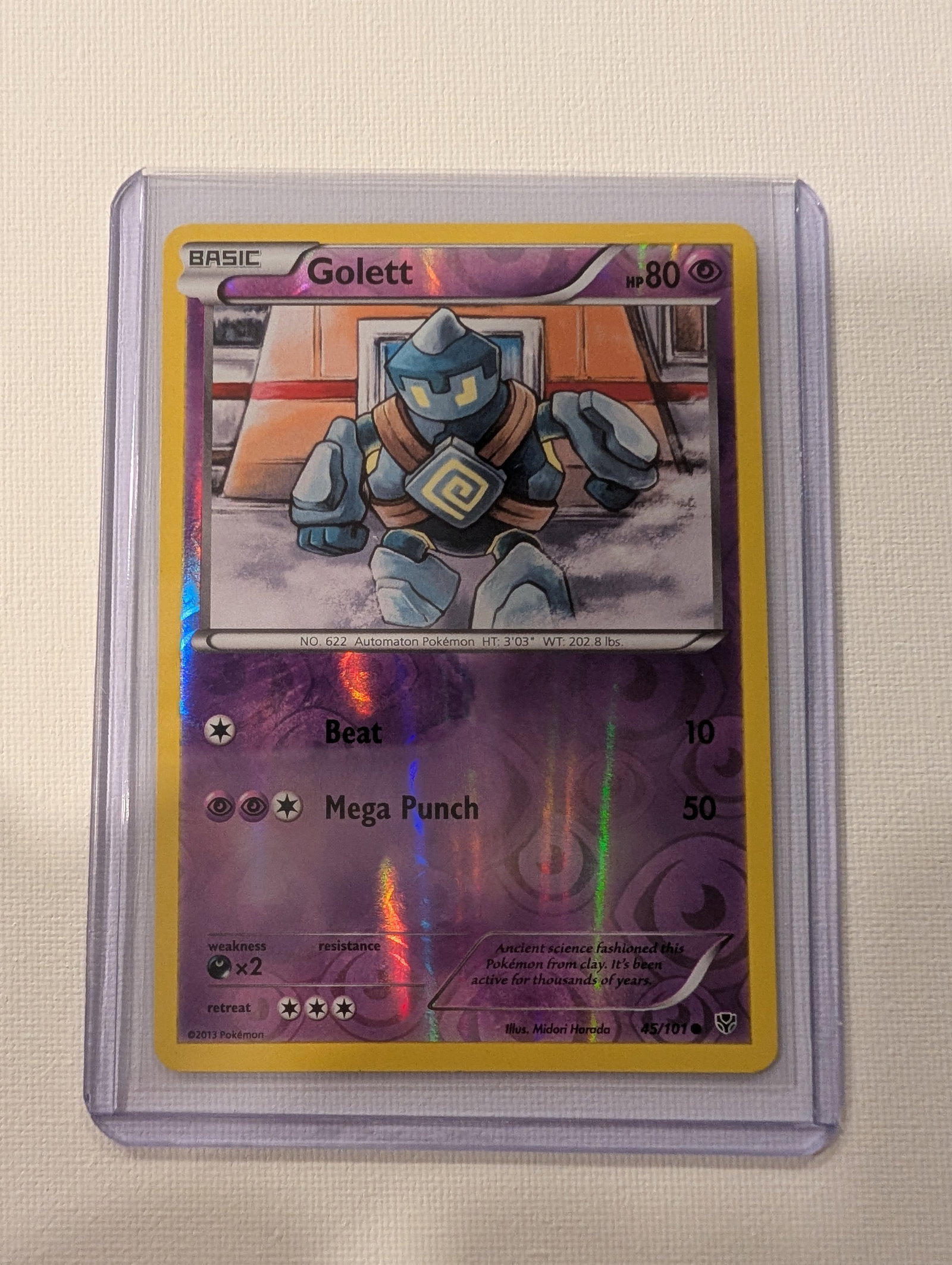 2013 Pokemon Golett 45 101 Black and White Plasma Blast Reverse Holo.: This lot is a Golett Reverse Holo card numbered 45 101 from the 2013 Plasma Blast expansion. It is a Psychic type Basic Pokemon with 80 HP and features artwork by Midori Harada. The card includes the