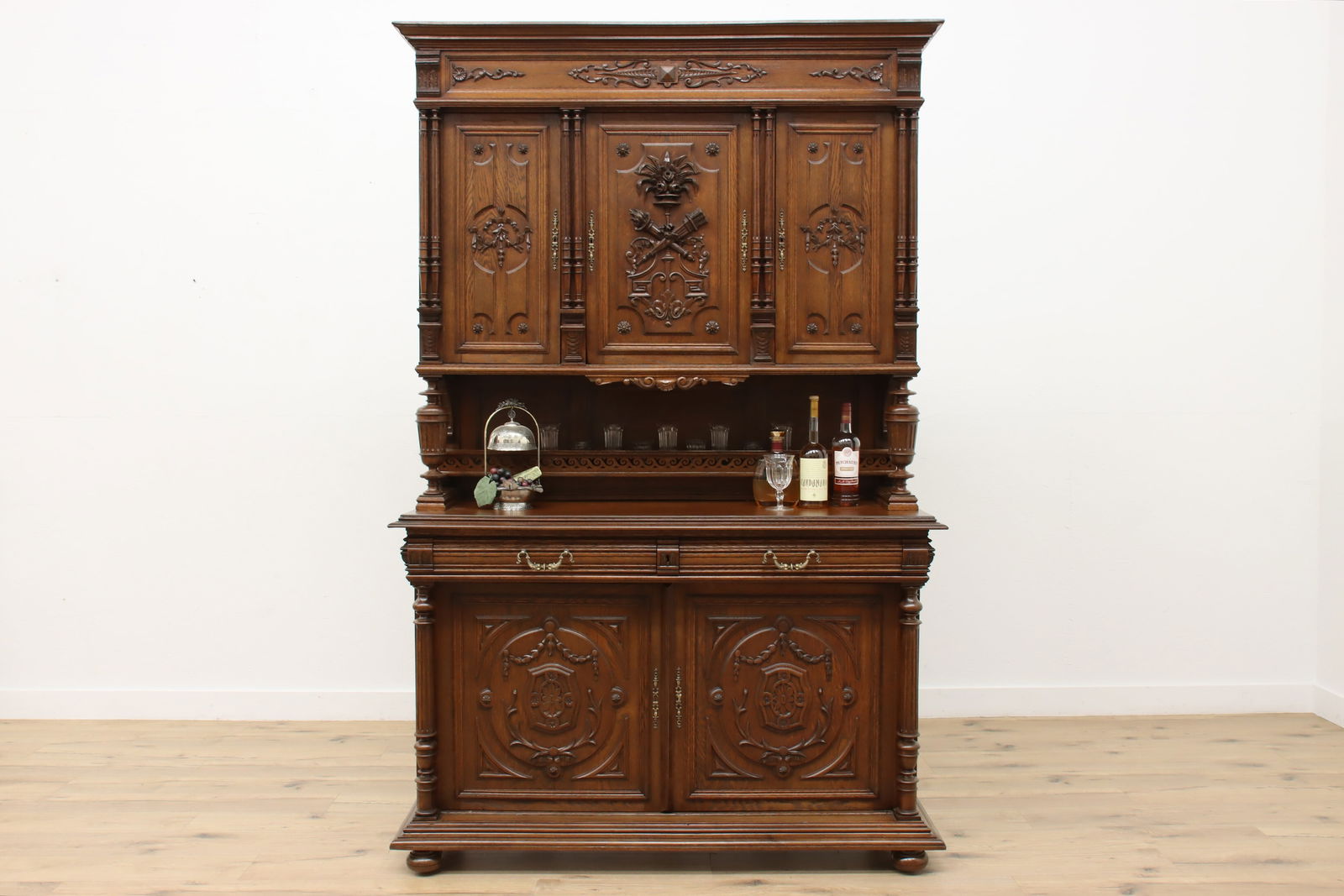 Renaissance Antique French Carved Oak Bar Sideboard Cabinet #48418: A fantastically carved Renaissance design bar cabinet or sideboard from France has a crossed torch and quiver of arrows motif. European antique 1900s furniture. Carved of solid oak with loads of quart