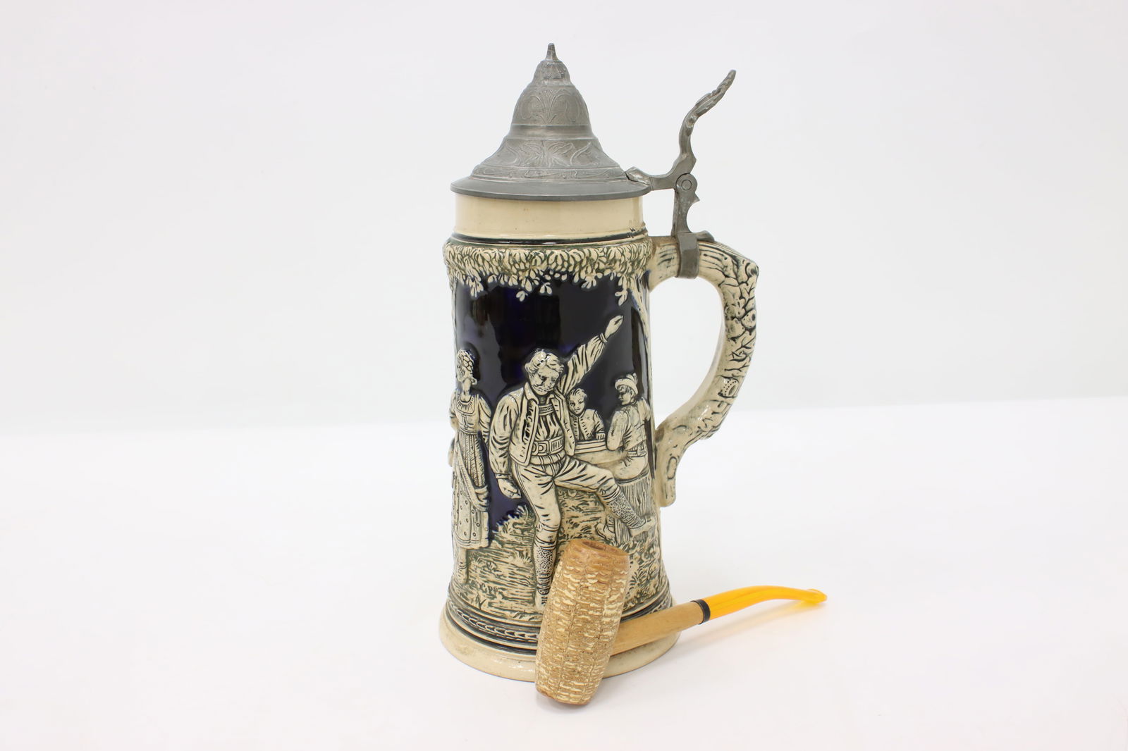 German Antique Stein or Mug Hand Painted Cobalt Pewter Lid #44555: A traditional German beer stein or mug is pottery with hand painted cobalt blue accents. Pewter lid. German made antique from early 1900s. Size is 5.5" x 9" and 12" tall.