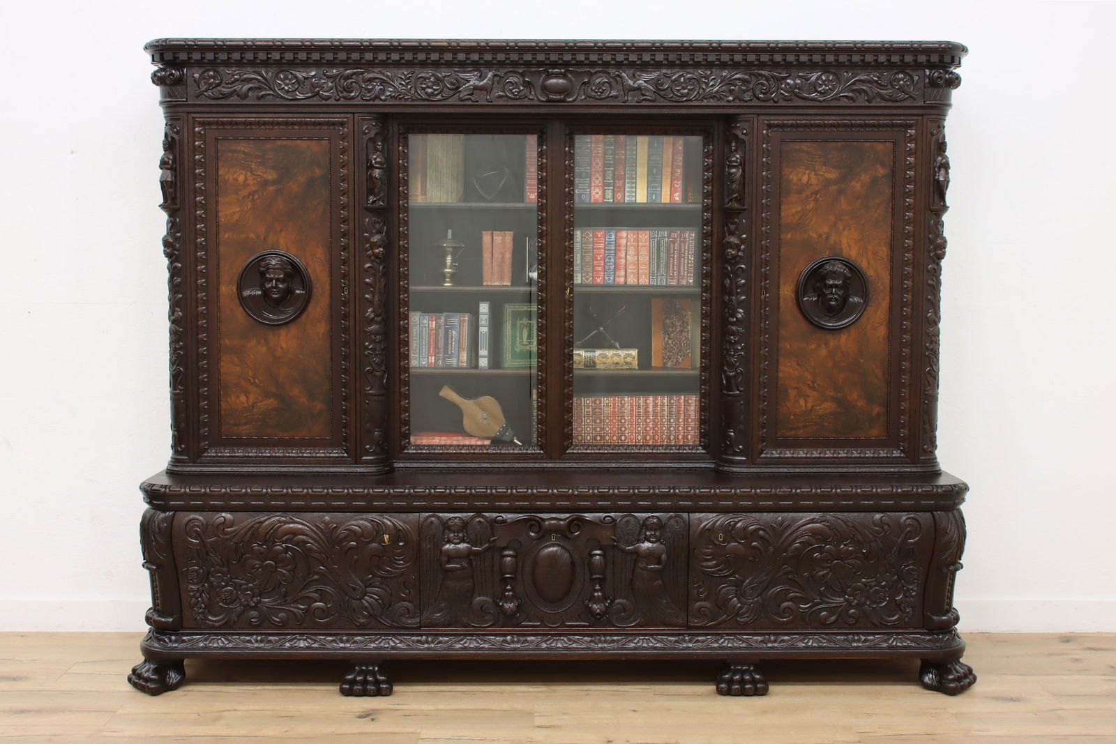 Renaissance Antique Oak Office Library Bookcase Carved Figures #47600: A stunning Renaissance design office or library bookcase has carved cherubs, three dimensional busts of a man and woman, and lion paw feet. Antique Lithuanian furniture from the Baltic States, dating