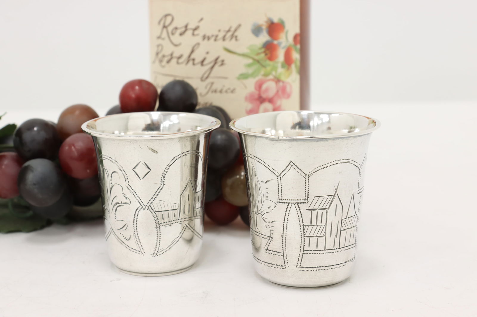 Pair of Antique Russian Engraved Silver Vodka Shot Glasses #47967: A pair of silver vodka or shot glasses have hand engraved folk art scenes of farms and flowers. Russian antique 1900s glasses.Marks on bottom are "84 Zolotnik", Russian measurement for .875 silver. Mi