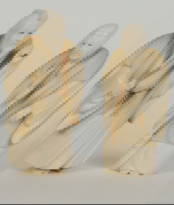 2 Ivory oriental figures: 2 Chinese Ivory figures (man and woman),; man H: 5-1/2" w/stamp in red under his foot. Piece broken off in right hand and also he is probably missing a staff in his left hand; the woman H: 5" appearin