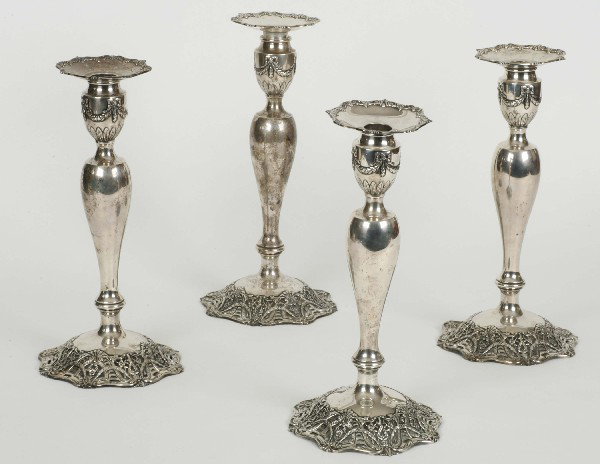 4 Black Star Frost Candlesticks 32oz: Set four sterling silver candlesticks having removable bobeches, drape and leaf design and all w/reticulated raised bases. The set marked Black Starr & Frost 5623/58. "Exclusive design weighted w/pitc