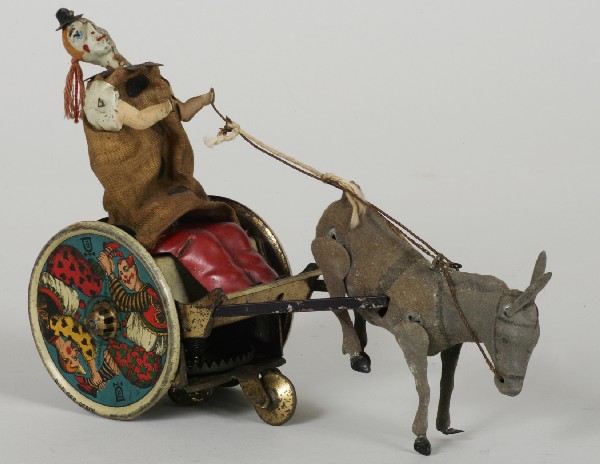 Bild Gesch, D.R. Clown In Donkey Cart Tin Toy: German mechanical Tin Toy (Clown in Donkey Cart) marked Marke, Bild Gesch, D.R. Patent, Engl. Patent and Made in Germany. size: H:5-1/4", L:7-1/4". Prov, a Roque Bluffs, ME estate