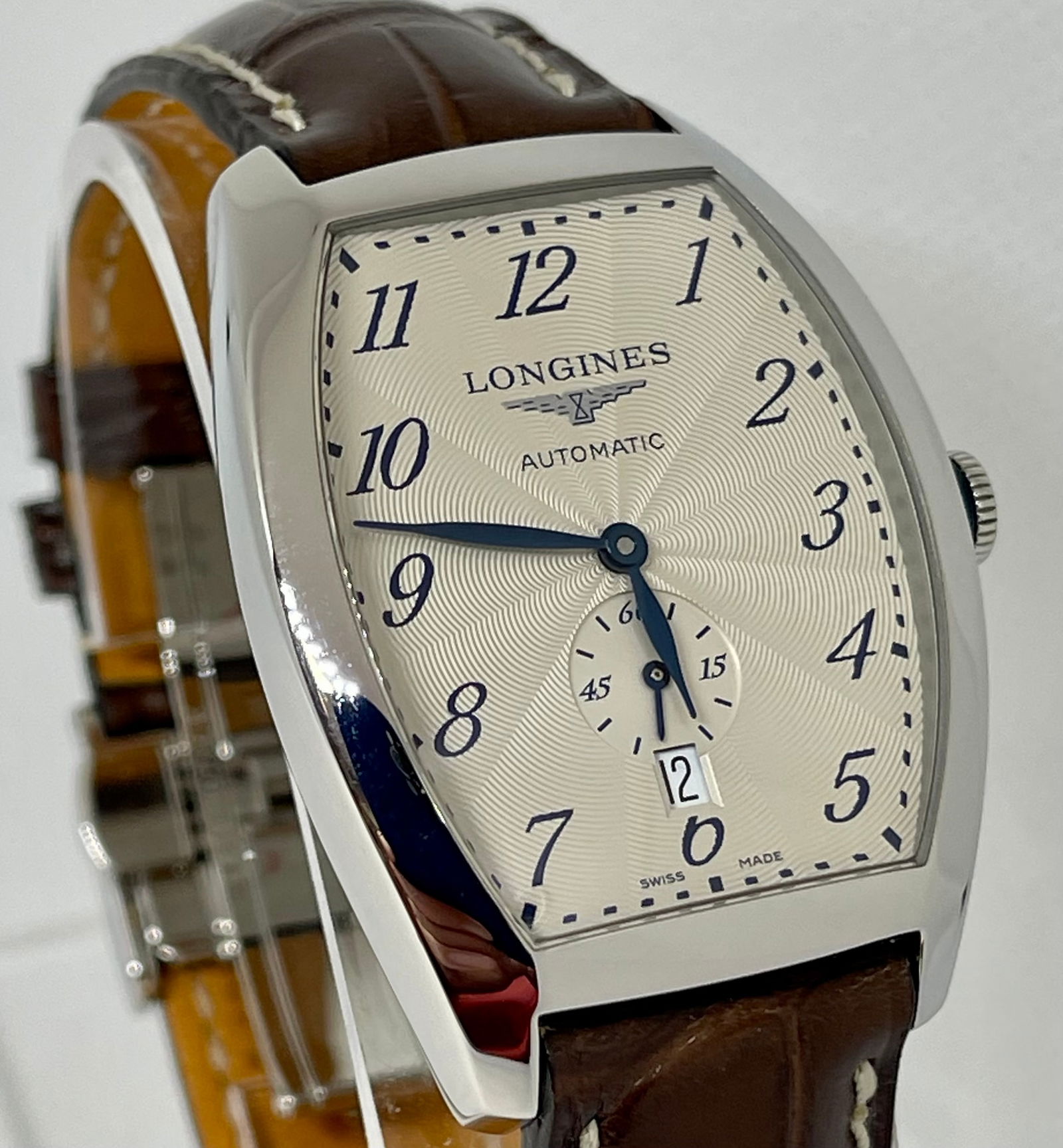 Longines - Evidenza Mens Watch: Stainless steel case with a brown (alligator) leather strap. Fixed stainless steel bezel. Silver flinque dial with blue hands and Arabic numeral hour markers. Minute markers around the outer rim. Dial