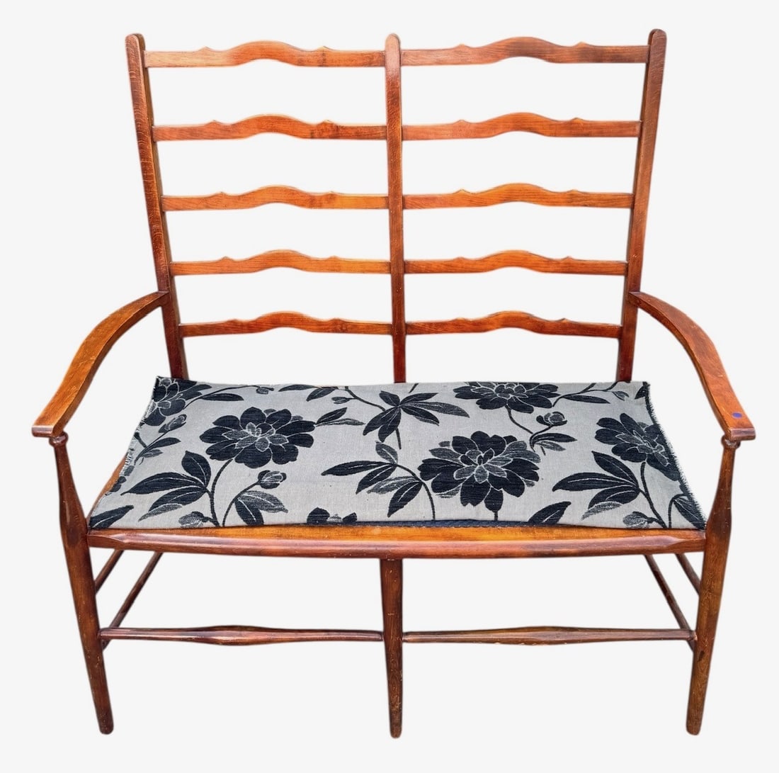 A LATE 19TH CENTURY ARTS & CRAFTS LADDER BACK BENCH With upholstered seat, raised on turned legs: A LATE 19TH CENTURY ARTS & CRAFTS LADDER BACK BENCH With upholstered seat, raised on turned legs joined by stretcher. (h 111cm x d 46cm x w 108cm)