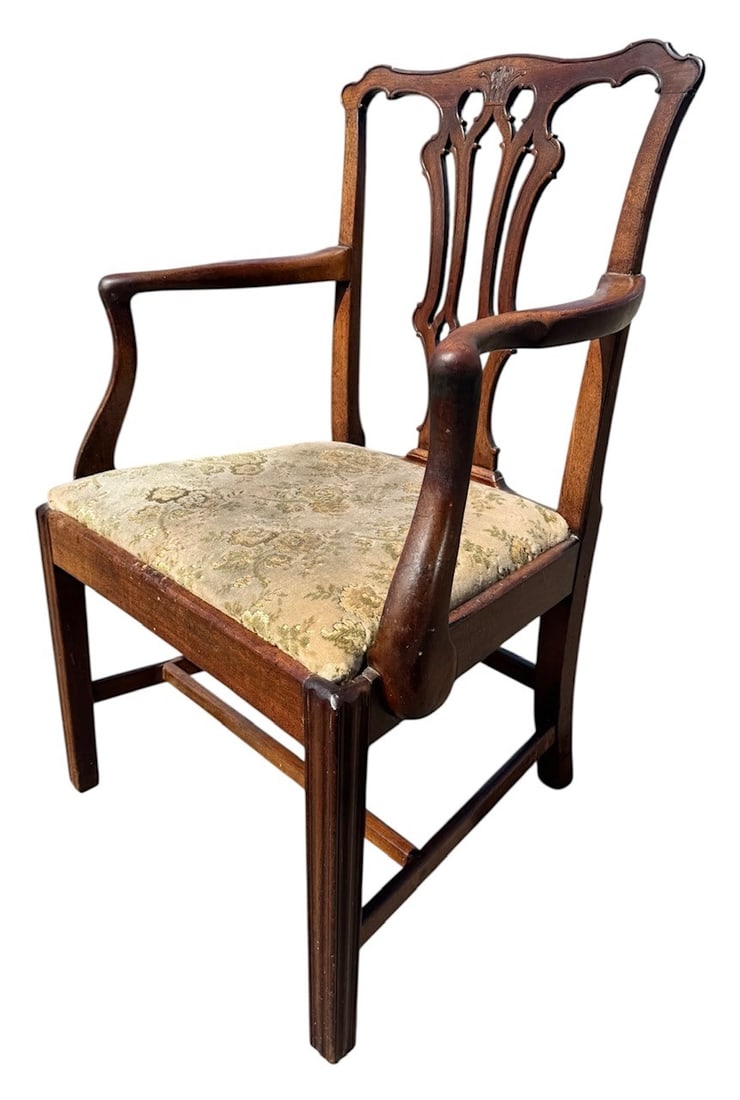 MANNER OF THOMAS CHIPPENDALE, AN 18TH CENTURY CARVED MAHOGANY ARMCHAIR With pierced back above: MANNER OF THOMAS CHIPPENDALE, AN 18TH CENTURY CARVED MAHOGANY ARMCHAIR With pierced back above drop in seat, raised on square legs.