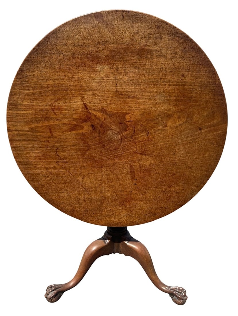 AN 18TH CENTURY GEORGE III SOLID MAHOGANY TRIPOD TABLE The circular top supported on a turned: AN 18TH CENTURY GEORGE III SOLID MAHOGANY TRIPOD TABLE The circular top supported on a turned column, raised on three cabriole legs terminating on ball and claw feet with brass and leather casters. (h