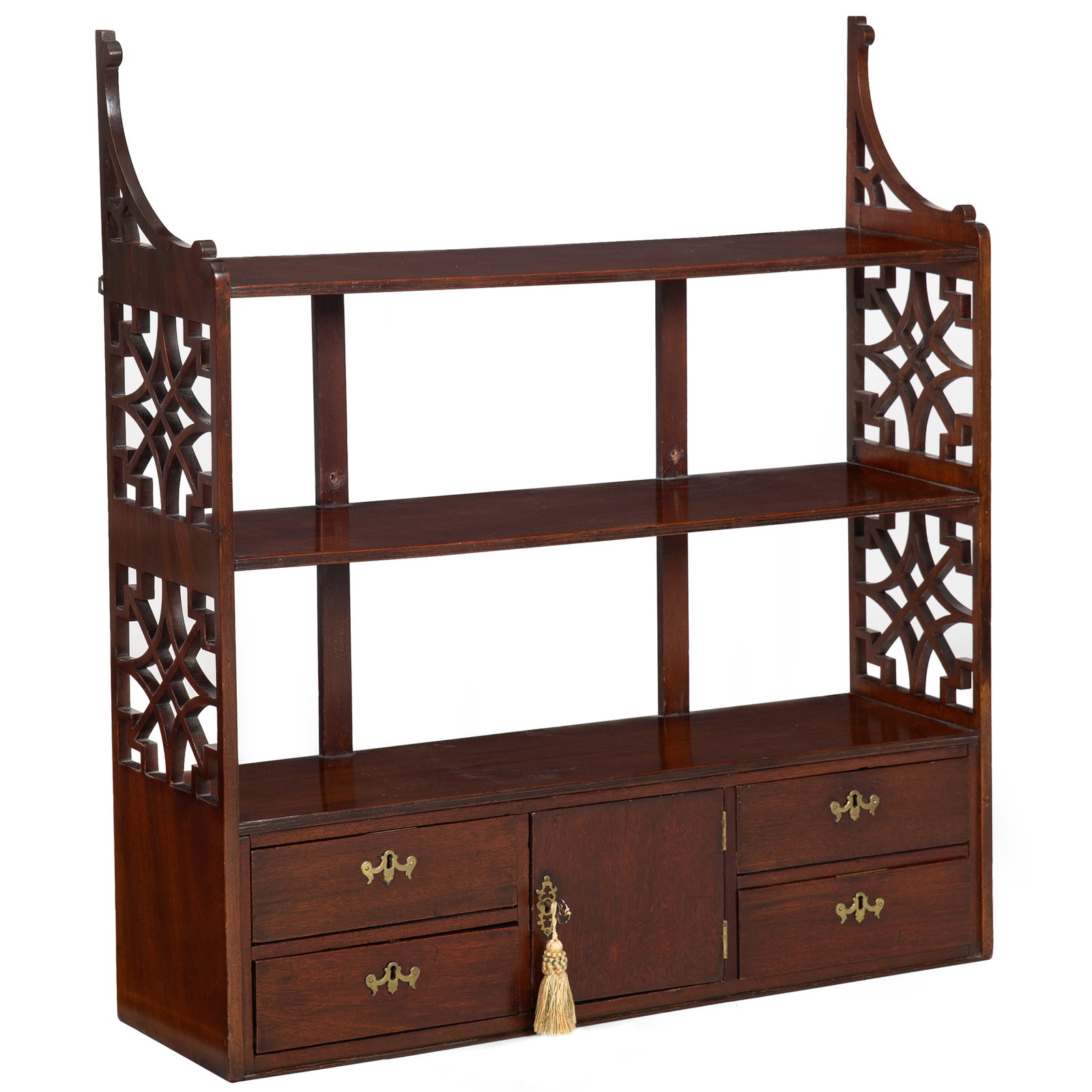 English Chippendale Pierced Bracket Three-Shelf Hanging Wall Rack circa 1780: English Chippendale Mahogany Hanging Shelves England, circa 1780. Mahogany hanging shelves in the Chippendale taste, with three graduated open tiers framed by pierced fretwork side panels. The lower s