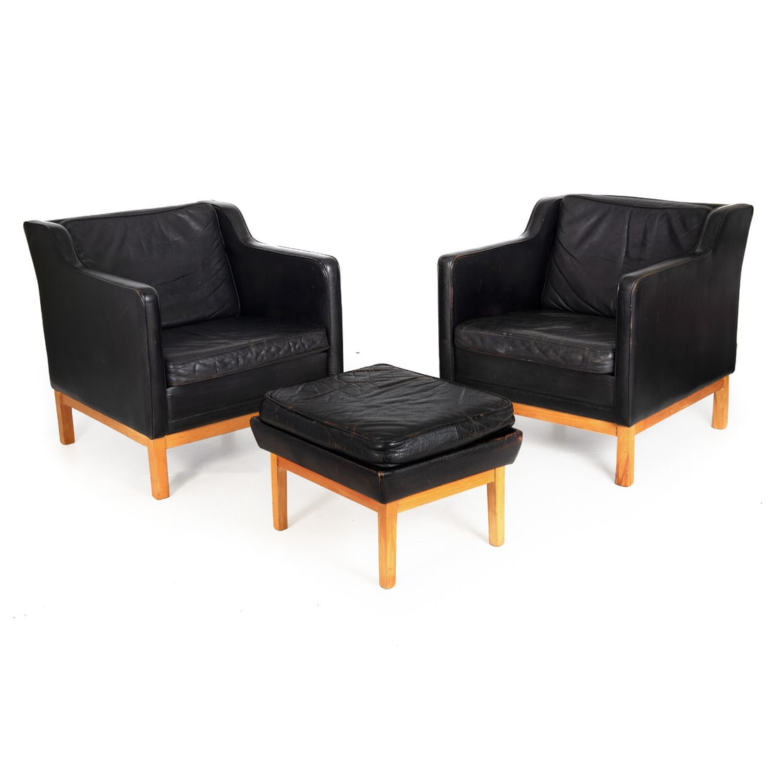 Pair of Mogens Hansen MH195 Low-Back Leather Armchairs with Ottoman: A pair of mid-century modern Mogens Hansen MH195 low-back armchairs with matching ottoman, retaining their original black top-grain leather upholstery over solid blond beechwood frames. The leather ha