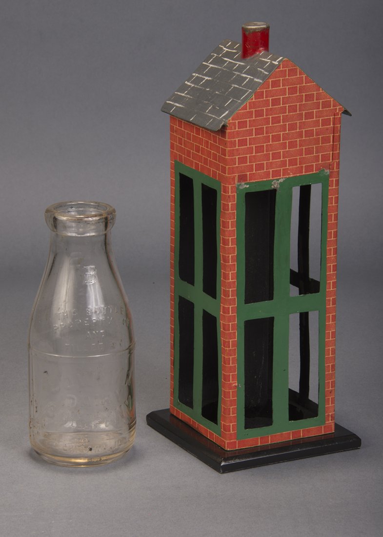 Histed Milk Bar - Louis Histed: English. A bottle of milk is placed inside of a small metal chimney, decorated as a building. The level of the milk visibly descends until the bottle is empty. The empty bottle may be passed for exami