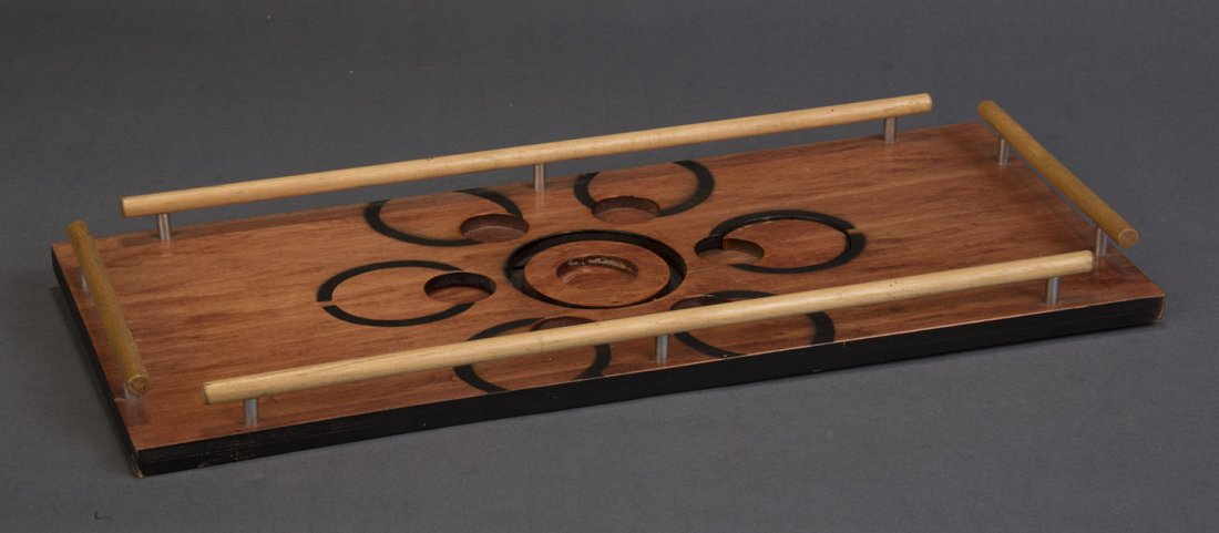 Abbott Hole In One: Six colored balls are shown atop a wooden tray. In the center of the tray is placed a shot glass, which is covered by an inverted clear glass tumbler. One of the colored balls is named by a spectator.