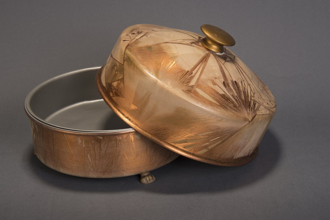 Double Load Dove Pan – Petrie & Lewis: From Petrie & Lewis, New Haven, CT. A meatal chaffing dish is shown empty. The bowl of the dish is set on fire. The cover is placed on the dish to extinguish the flame. When the lid is removed, a live