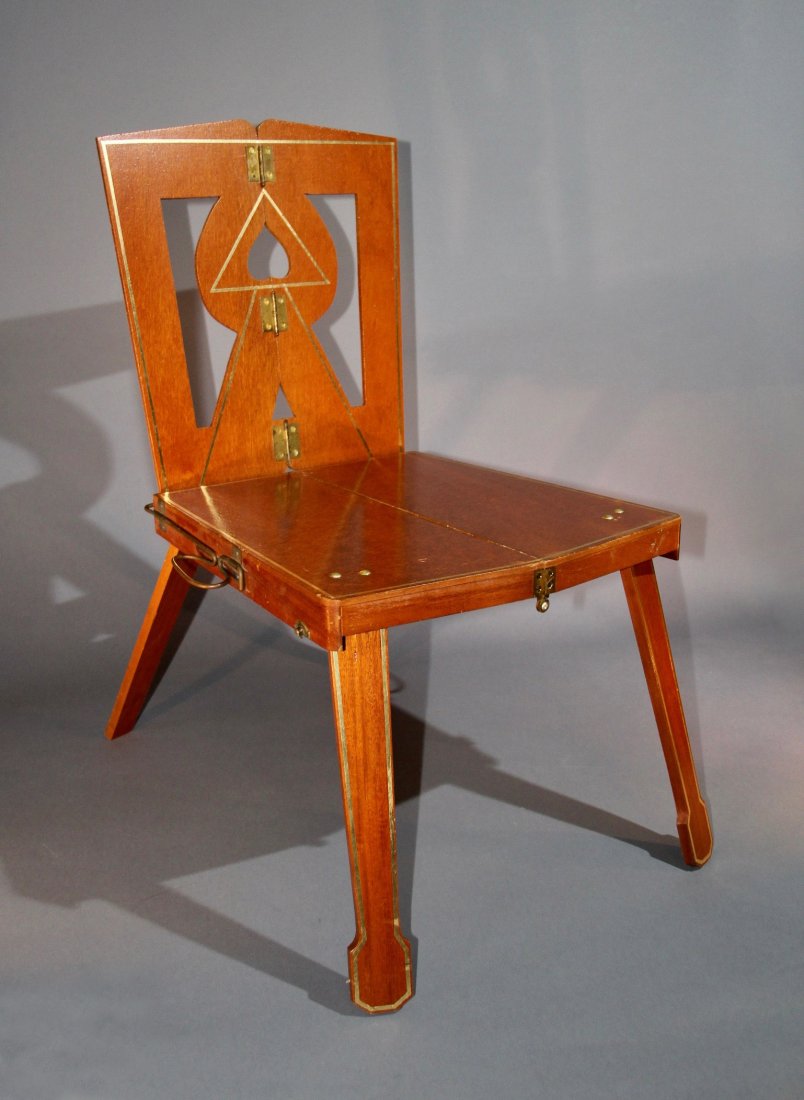 CHAIR TO SUITCASE – NATURAL FINISH: A small chair is seen onstage throughout the performer’s act. Objects may be set on the chair as needed. At the conclusion of the act, the performer picks up the chair by the seat and with a deft fl