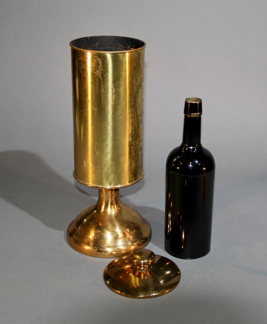 LARGE BRASS FLAG VASE: European. Circa 1930. A 16 ½” tall brass vase is shown and filled with water. The lid is placed on top and when removed, a large production of flags is made (not included), concluding with the prod
