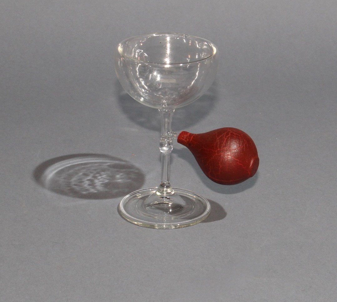 RE-FILLING GLASS: Maker unknown. An earlier (and larger) version of Abbott’s “Gizmo Glass” in which liquid in a champagne glass repeatedly vanishes and reappears or the magician may apparently drink it, only to f