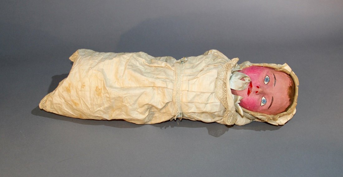 SPRING BABY – LARGE: Bland? Life-sized baby with an internal spring body that may be compressed to fit inside of a hat or a variety of apparatus. Papier mache face. Finely detailed. Circa 1890. Measures 23” long. Possib