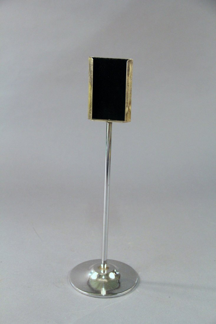 Card Changing Pedestal: Circa 1940. A card is placed in a holder atop a 15” tall stand, and covered with a handkerchief. When the handkerchief is removed, the card is seen to have vanished or transformed into a different c