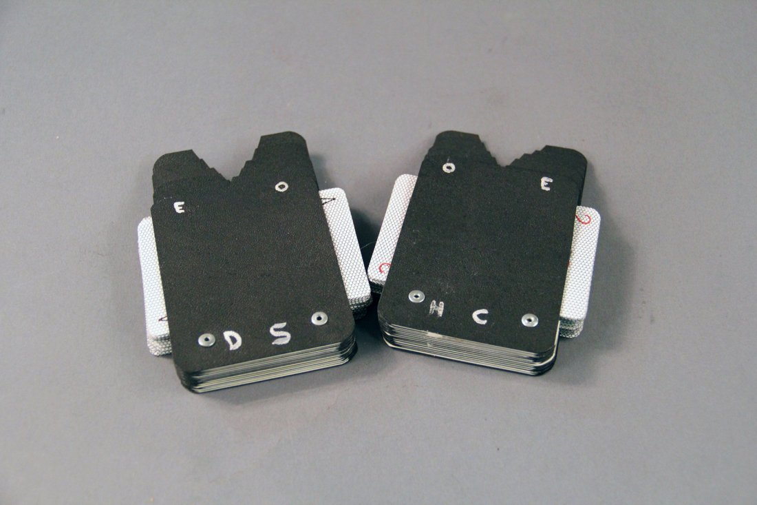 Card Indexes: A deck of cards is thoroughly shuffled by the spectators and divided in two. Each half of the deck is placed in the magician’s outside jacket pockets. Then, any card named by the spectators is immed