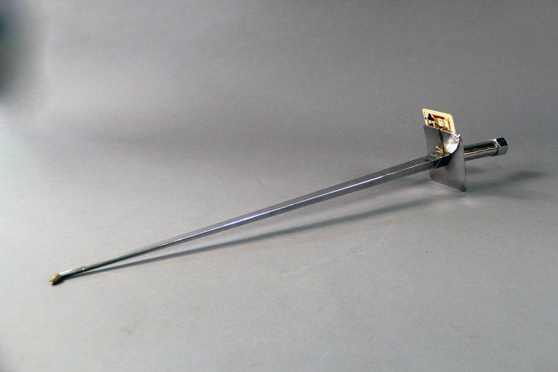 Card Sword: Circa 1940. Plated 29” rapier-style sword with curved hilt conceals 3 cards that will appear on the tip of the sword. Condition: good. Some wear to plating from age.