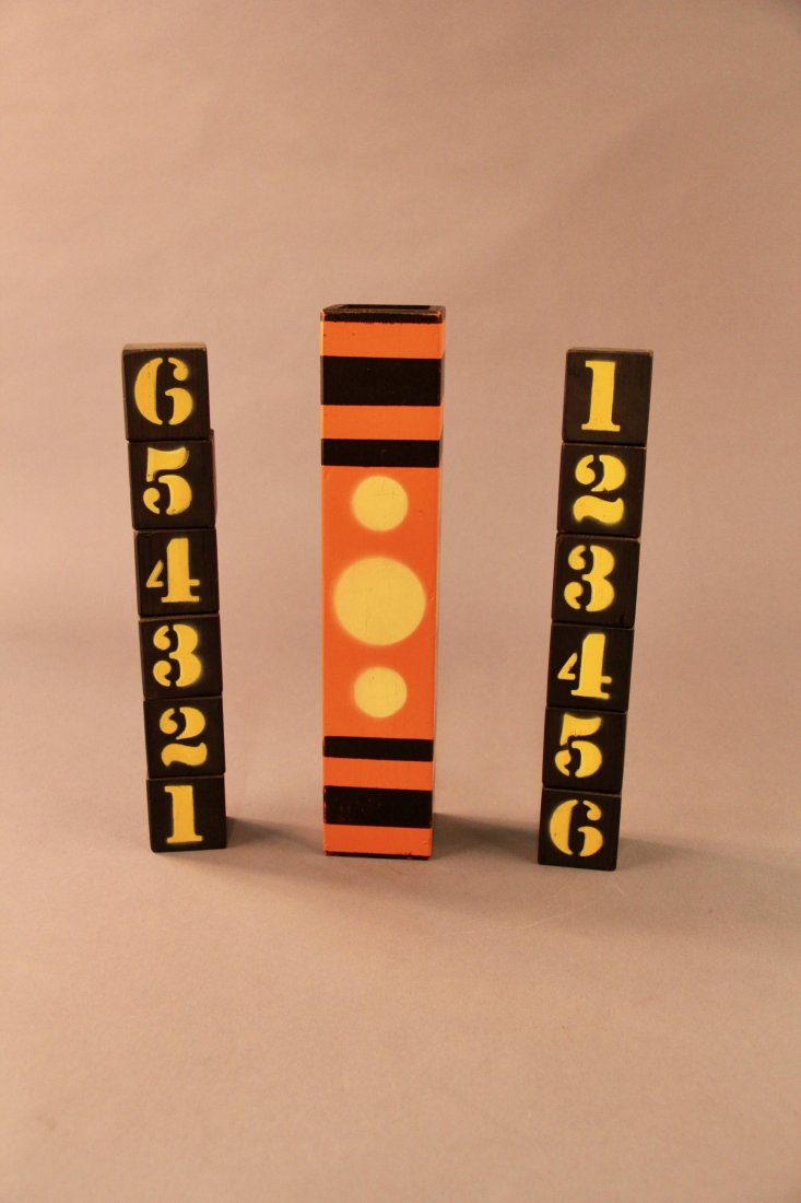 Cube-A-Libre - House of Magic: (Buma Burger), circa 1970. Smaller version of the Conradi block trick using a stack of six, 2” numbered cubes that rearrange position under a decorative tube in sympathy with the other stack of bloc