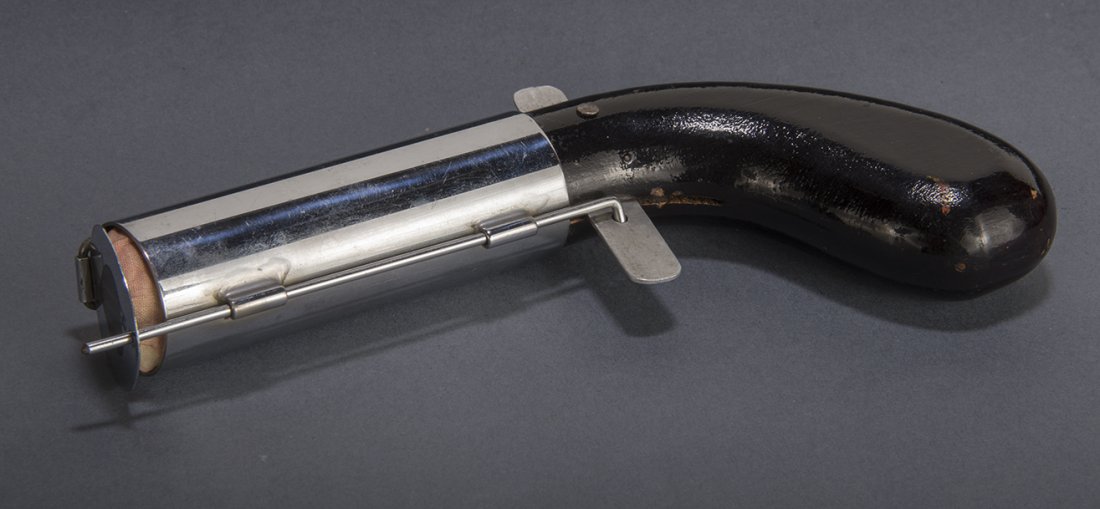 Sausage Gun - Arthur Culpin: Pull the trigger on this oversized "pistol" and a string of pink, spring sausages shoots forth. Very uncommon. Black enamel with chrome plated barrel. Condition: Near mint.
