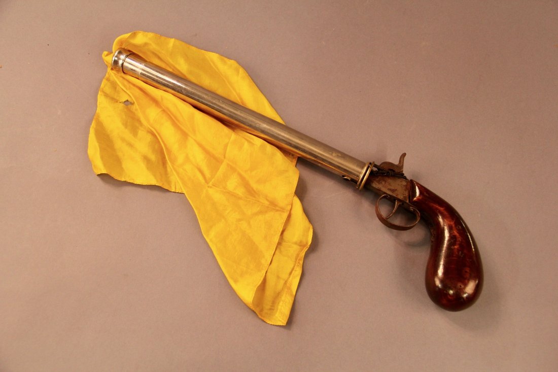 Silk Vanishing Pistol: Circa 1910. A silk handkerchief is placed over the barrel of a gun and when fired, the silk instantly vanishes. Percussion cap style pistol. Condition: Very good with some wear from age/use.