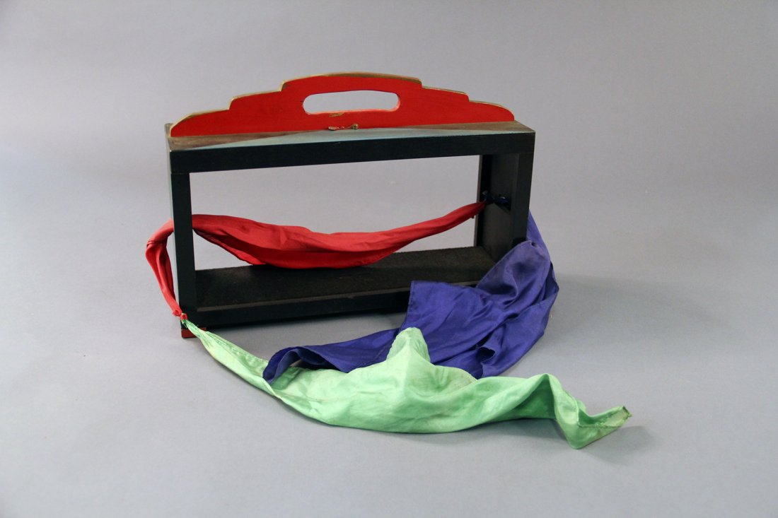 Thayer Visible 20th Century Silks: Circa 1940. A Loyd effect. Two silks threaded through a wooden framework are tied together. A third silk is vanished and visibly reappears tied between the two silks in the frame. Condition: Very good