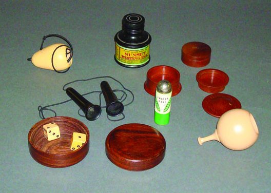 (Apparatus) Eight Items: Coin Box. Sureshot Dice: (Apparatus) Eight Items: Coin Box. Sureshot Dice Box. Silk Pull. Cig Pulls. "Two" Peas in a Can (very rare). Ink Bottle. Stamp Box. Thayer, Thayer Magic, ca. 1925. A magnificent collection of turned i