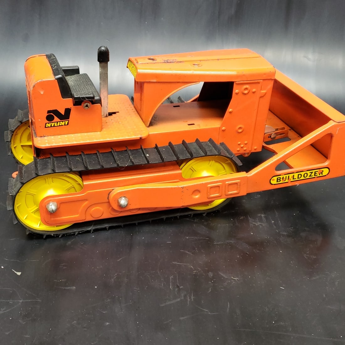 60's Nylint Pressed Steel Bulldozer: "Fresh to market from a lifetime collector. A nice selection of vintage tin and pressed steel along with die cast model and car related ephemera. All measurements are approximate.