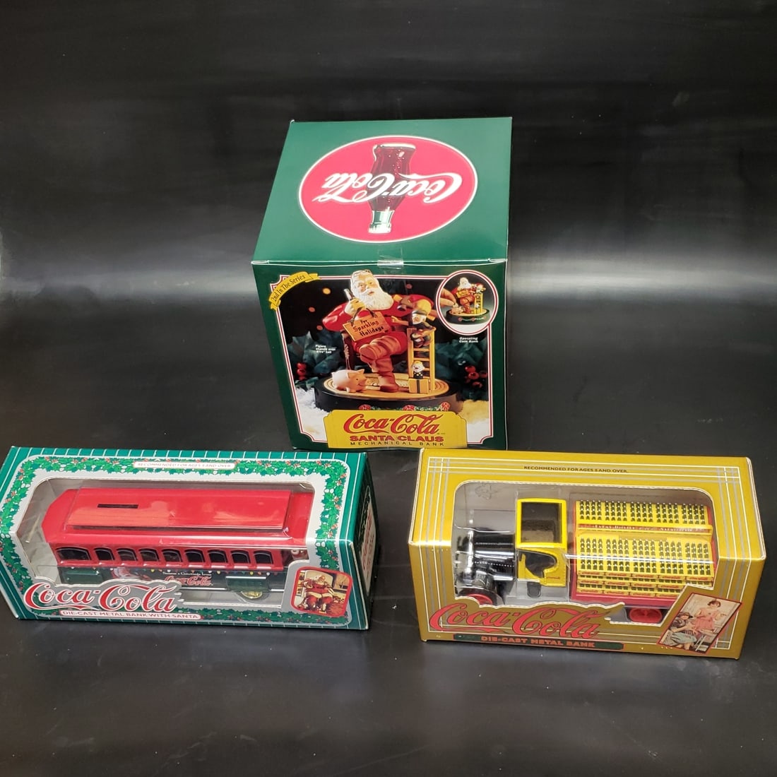 Selection of Coca Cola Die Cast Models / Banks Santa Christmas: "Fresh to market from a lifetime collector. A nice selection of vintage tin and pressed steel along with die cast model and car related ephemera. All measurements are approximate.