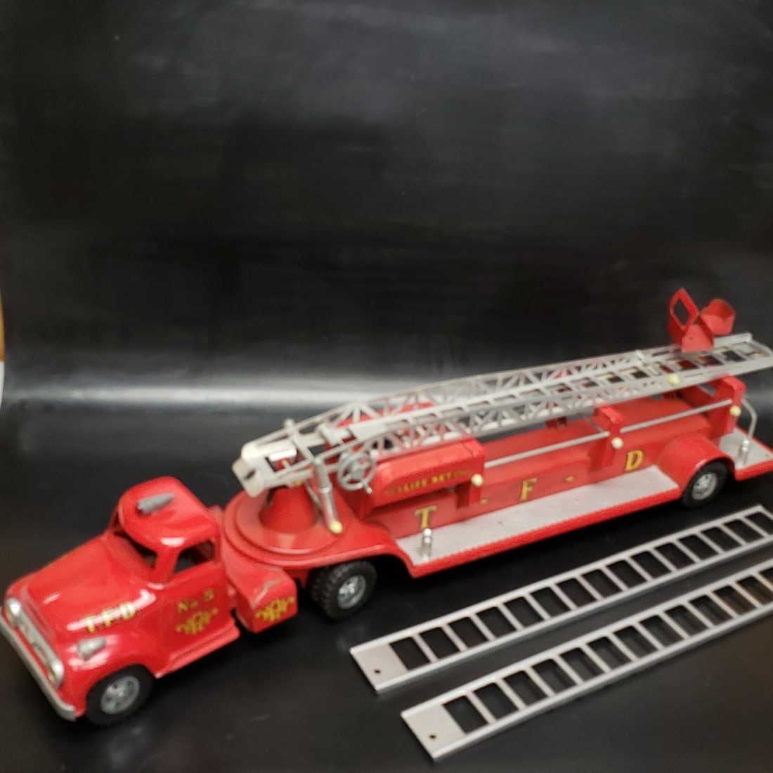 Tonka 1950's No 5 Ladder Fire Truck: "Fresh to market from a lifetime collector. A nice selection of vintage tin and pressed steel along with die cast model and car related ephemera. All measurements are approximate.