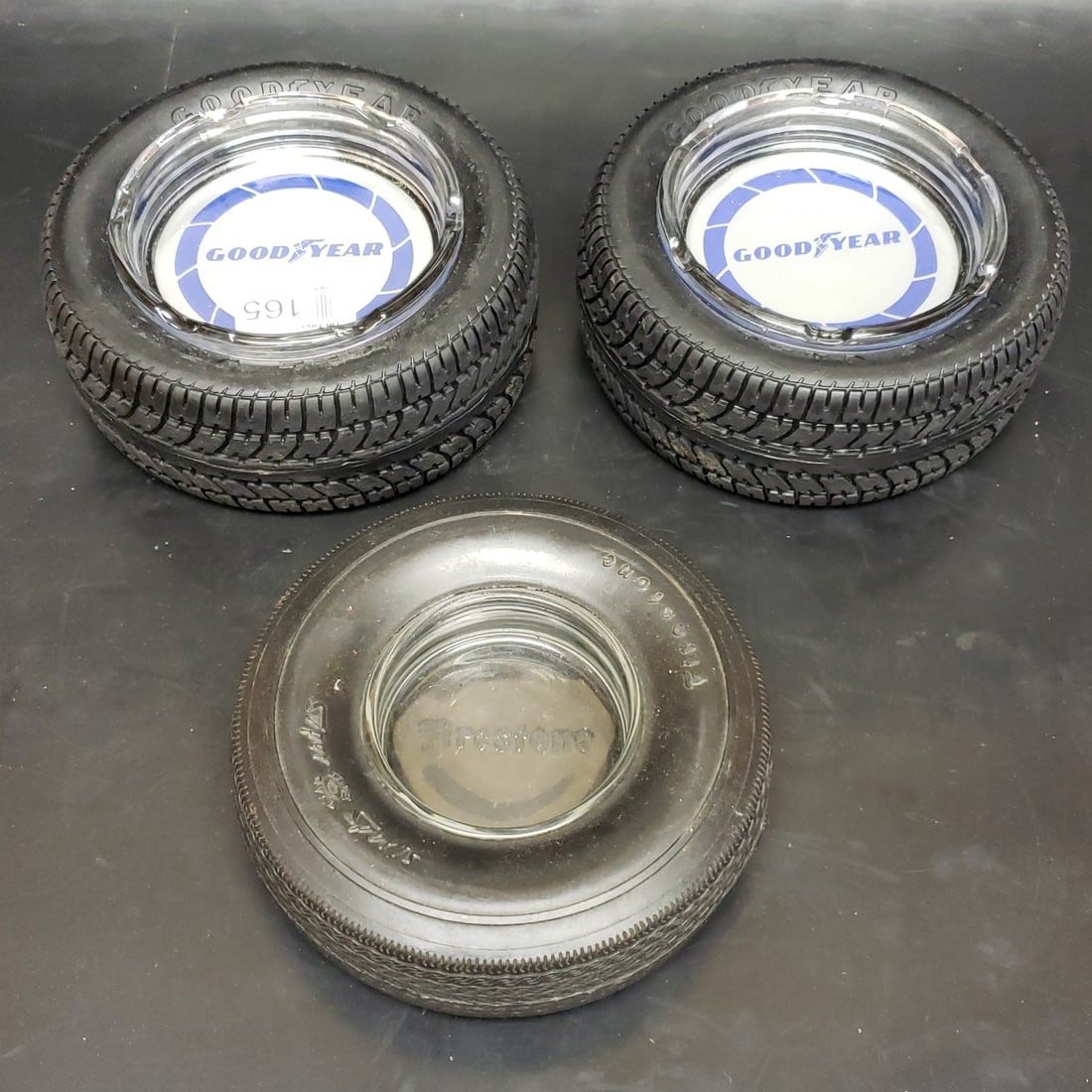 3 x Adverting Tire Ashtrays Goodyear Firestone: "Fresh to market from a lifetime collector. A nice selection of vintage tin and pressed steel along with die cast model and car related ephemera. All measurements are approximate.